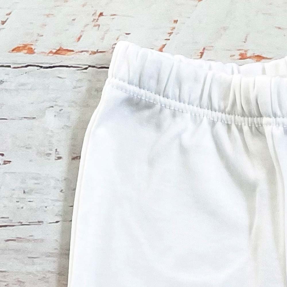 Pantalón blanco básico con pretina elástica y pierna lisa