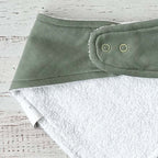 Bandana verde triangular con broches circulares en el cuello y reverso blanco