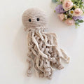 Medusa de crochet color beige con ojos bordados y largas puntas tejidas