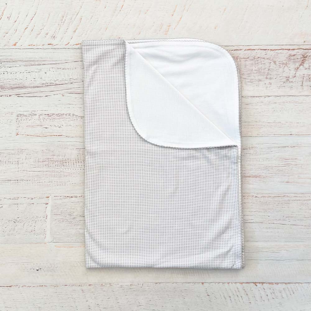 Manta jacquard de cuadros clara, vista del reverso con costura