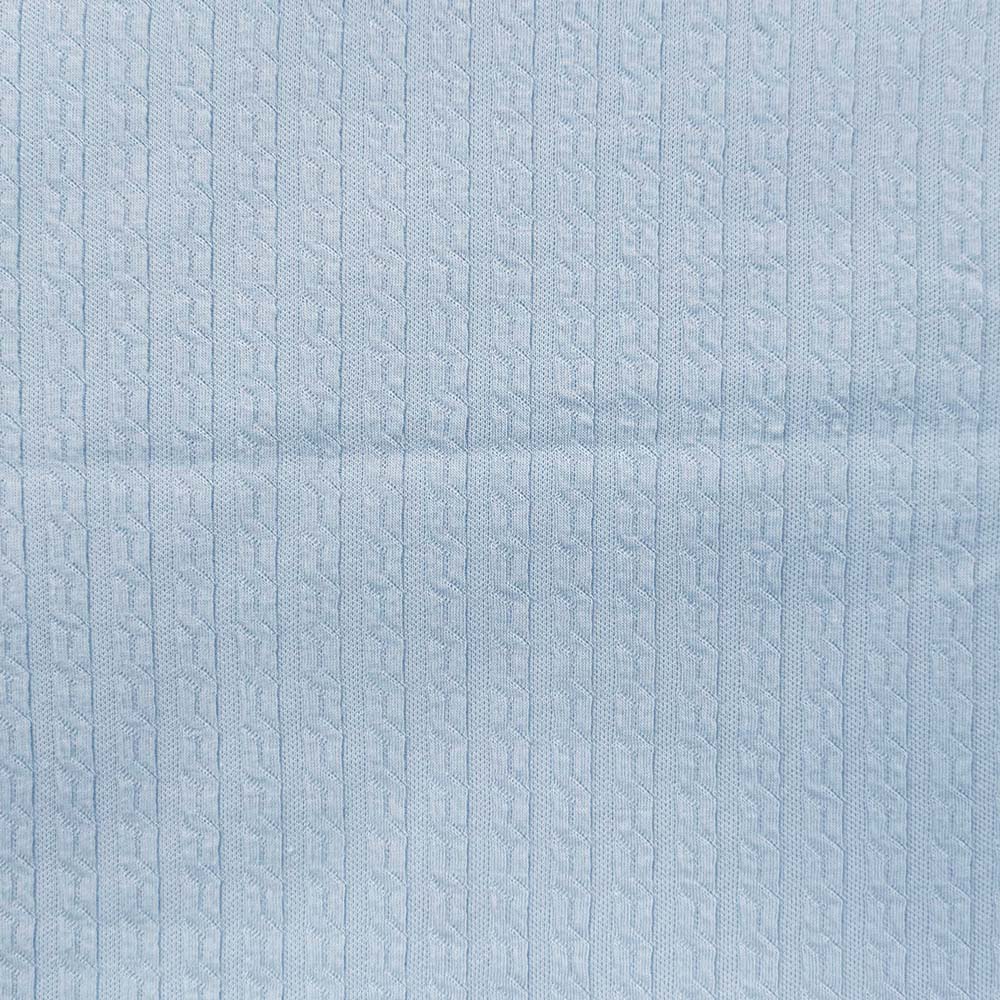 Manta jacquard celeste con patrón en relieve repetido, vista del tejido