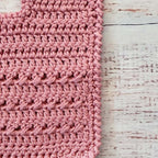 Babero de crochet palo rosa con tejido en punto trenzado