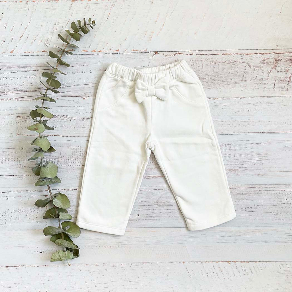 Pantalón de bebé blanco con cintura elástica y moño delantero, pierna recta